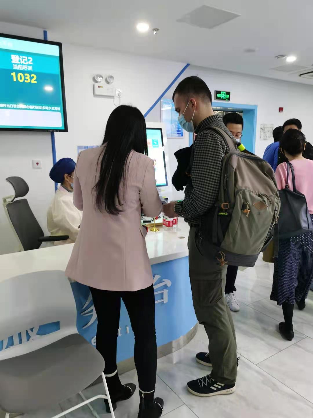 志愿者为来中心接种的外籍人士做解释工作.jpg